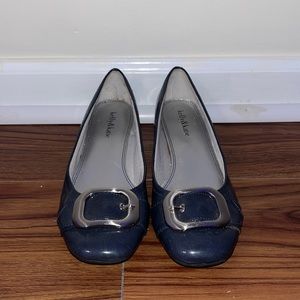 dark grey flats with a small heel and buckle strap